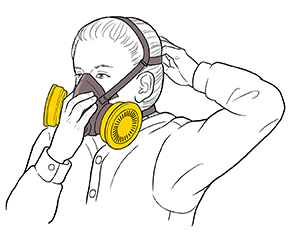 Woman putting on half-mask respirator.