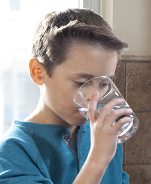 Boy drinking water.